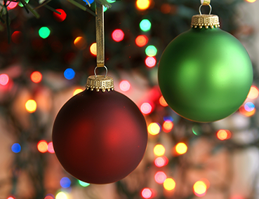 christmas ornaments with lights in the background
